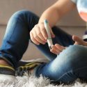 Boy tests his blood sugar levels at home